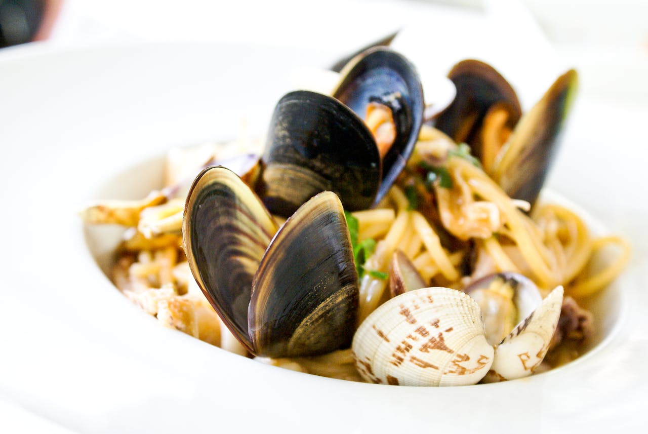about-us-01 Close-up of Italian seafood pasta with clams and mussels served in Florence.